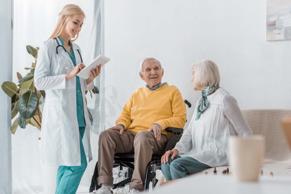 registered nurse talking to elderly man and woman