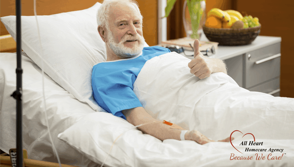 smiling bed-bound patient with his thumb up